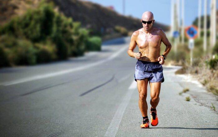 Man Over 50 Running Along Road Exercising