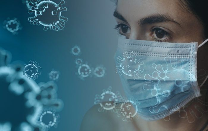 Woman Wearing Mask With Illustrations Of Coronavirus On Image