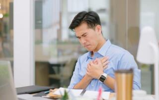 man holding heart in pain